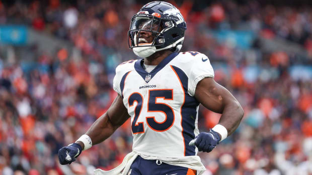 Broncos running back Melvin Gordon celebrates after scoring a touchdown in a game.